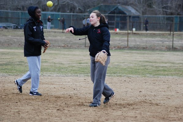 The Lady Whalers work on ground balls in practice on Friday. DREW BUDD