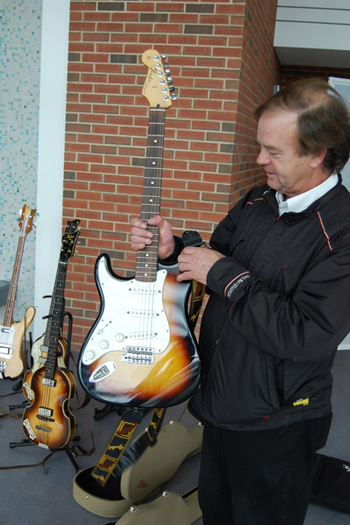 Bill Ray shows his son's Fender Stratocaster guitar. Mr. Ray's son plays guitar in Ever Present Past.