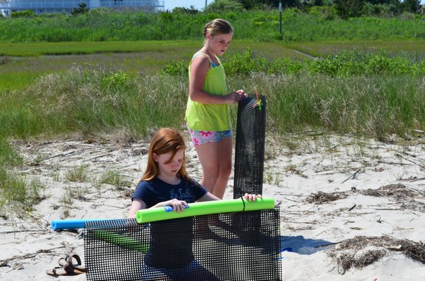 Megan Monaghan, left, and Leigh McLaughlin helped build oyster cages on Saturday. Alexa Gorman
