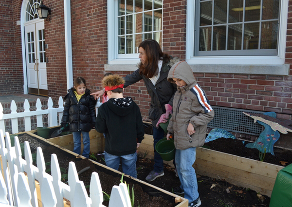 Students from Ms. Winter's second grade class at Quogue School work in their garden on Tuesday morning.