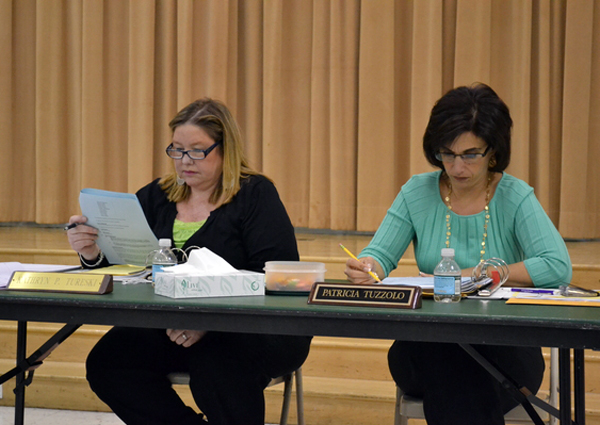 East Quogue Board of Education Vice President Kathryn Tureski, left, and member Patricia Tuzzolo review the agenda at a meeting on March 15.