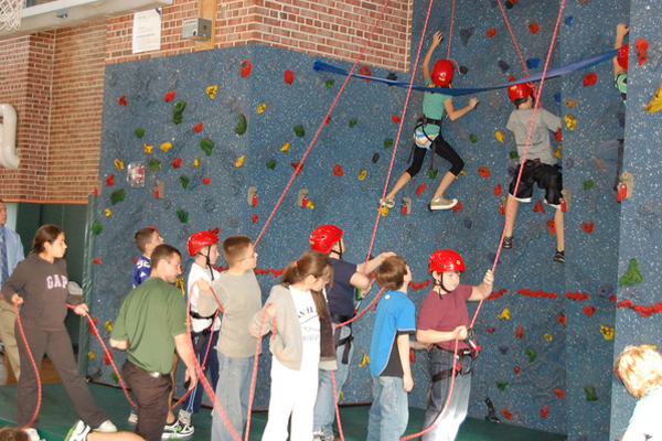 Westhampton Beach elementary students show off how they learned how climb the rock climbing wall.