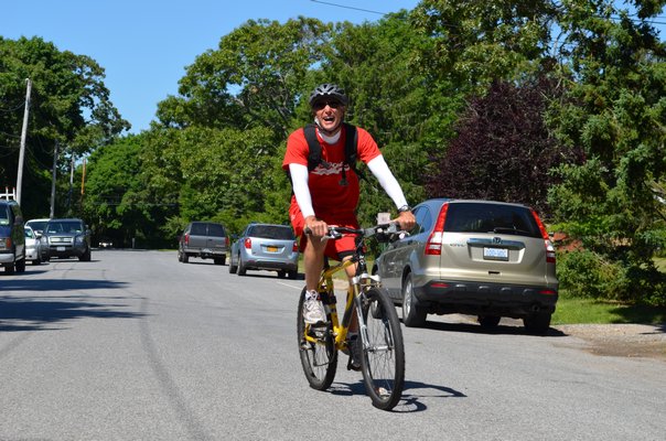 Tim Carbone, who is retiring after 39 years teaching at Quogue School, took his last "beach day" bike ride on Monday with the students. Alexa Gorman