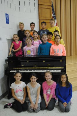 Students at East Quogue Elementary School were excited to see the new piano that was donated to them by singer Robin Thicke. AMANDA BERNOCCO