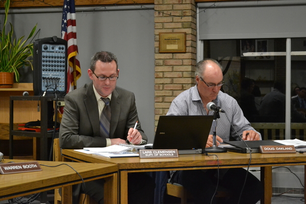 Hampton bays Superintendent of Schools Lars Clemensen and School Board President Doug Oakland listen as the budget is unveiled at Tuesday, April 12's meeting.