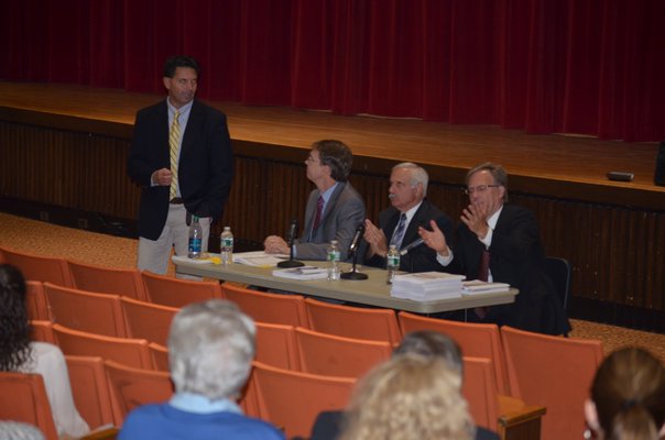 Southampton Superintendent Dr. Scott Farina, standing, with SES Study team members Doug Exley, left, Sam Shevat, and Paul Seversky, right, at the merger forum at Southampton High School on Wednesday night. BY ERIN MCKINLEY