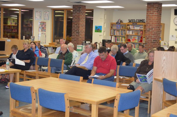 The community listens to a presentation at the merger study meeting held at the Tuckahoe School on Thursday. BY ERIN MCKINLEY