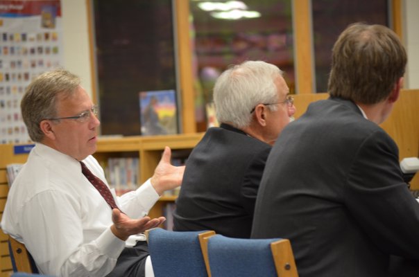 Hampton Bays Superintendent Lars Clemensen reads the motion for the school board to adopt the district's 2011-2012 budget.