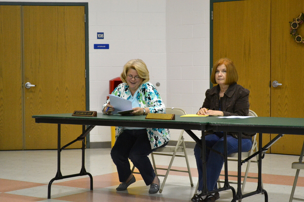 East Quogue Business Administrator Elizabeth Lev sits alongside District Clerk Lenore Rezza as the school board approves its 2011-2012 budget.