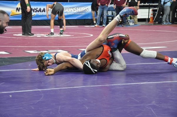 Hampton Bays junior Willy Kraus works against Mitchell Barcus of Eagle Academy at the New York State Division II Wrestling Championships. CRAIG MIELENHAUSEN