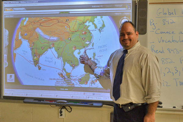 PJ Lopez points to China on a map of the world in his history classroom at the Hampton Bays High School.