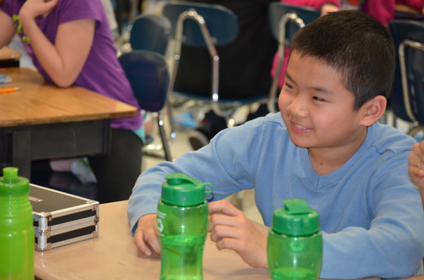 Kimmy Liu has his water bottle during class.