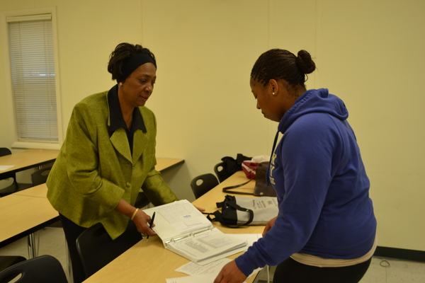 Professor Gwendolyn Branch works with a student at the Northampton Campus of Suffolk Community College on May 17. LAURA COOPER