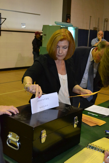 East Quogue District Clerk Lenore Rezza counts absentee ballots as election officials look on at the East Quogue School on Central Avenue following Tuesday's budget vote. LAURA COOPER