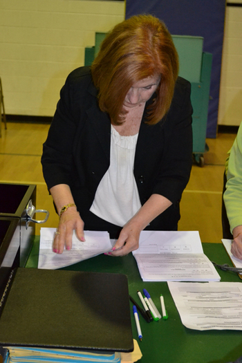 East Quogue District Clerk Lenore Rezza counts absentee ballots following Tuesday night's budget vote. LAURA COOPER