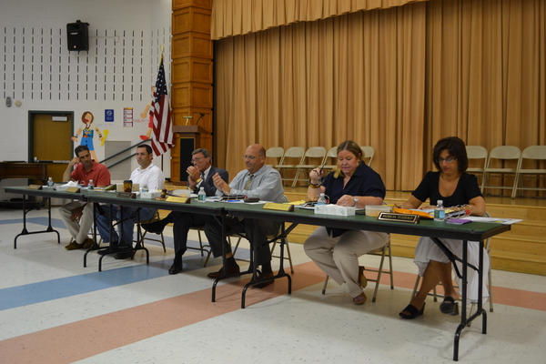 East Quogue School Board President Mario Cardaci and Superintendent Les Black sit alongside the School Board after they approved the addition of a kindergarten class.