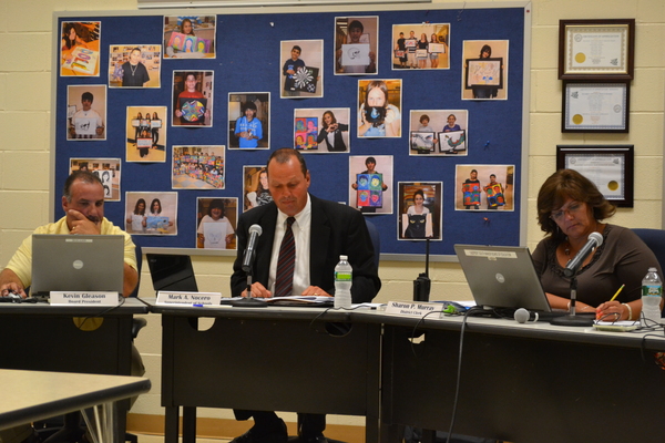 Superintendent Mark Nocero sits beside School Board President Kevin Gleason and District Clerk Sharon Murray at a meeting of the Eastport South Manor Board of Education. LAURA COOPER