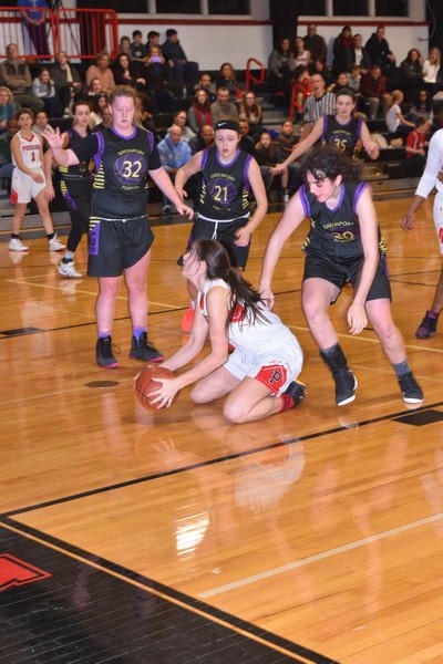 Pierson senior Katie Kneeland picks up a loose ball in front of a trio of Greenport players. DREW BUDD