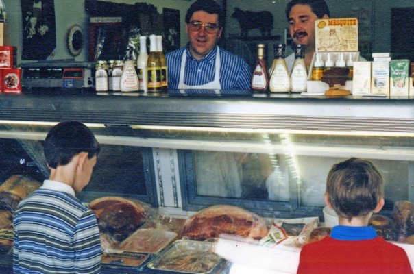 Eddie Dean behind the counter at Dean's Market with his son, Bryan. COURTESY DEAN FAMILY