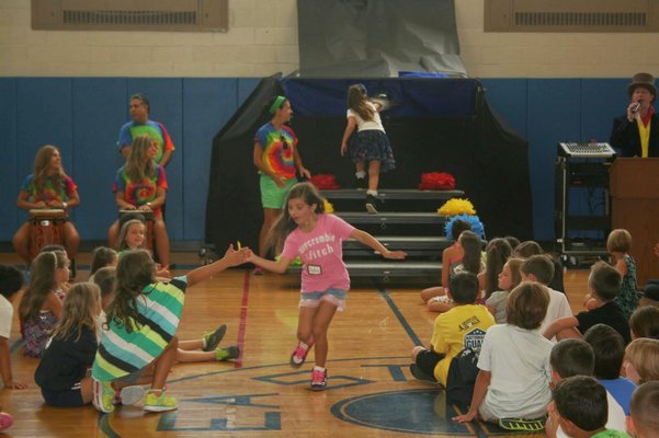 Sophie Rambelle high-fives students during the sorting ceremony at Eastport Elementary School. COURTESY EASTPORT ELEMENTARY SCHOOL