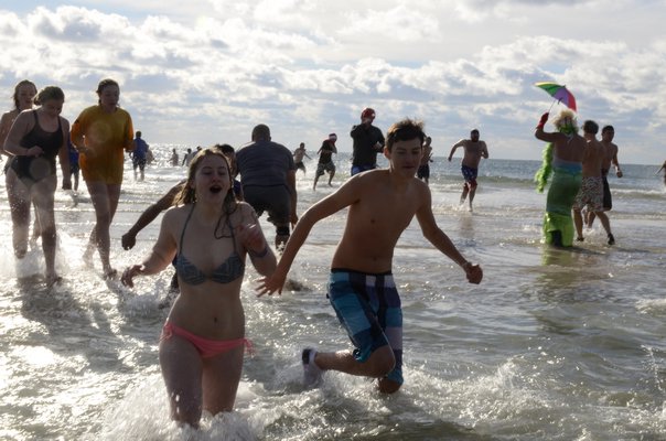 The 13th annual Polar Bear Plunge at Coopers Beach in Southampton on Saturday. BY GREG WEHNER