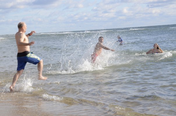 The 13th annual Polar Bear Plunge at Coopers Beach in Southampton on Saturday. BY GREG WEHNER