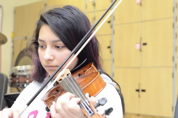 Nicole Gutierrez, a freshman at Southampton High School, has been playing the violin since kindergarten, which is when students are first given the opportunity to play a stringed instrument in the school district. GREG WEHNER