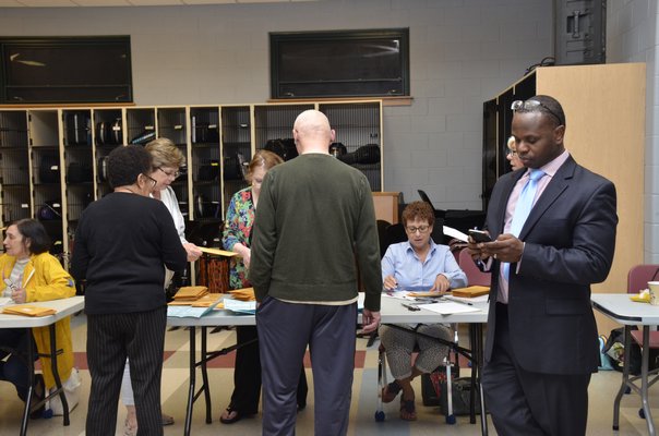 Southampton School Election officials count absentee ballots on Tuesday night. GREG WEHNER