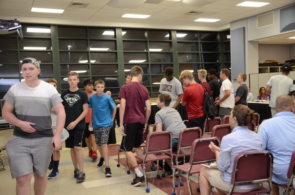Members of the Southampton High School football team attended the school board meeting on Tuesday in support of their coach Eddie West who was suspended after flushing a player's marijuana down the school toilet and not reporting the incident to school officials. GREG WEHNER