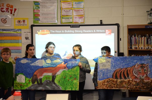 5th grade students at Westhampton Beach Elementary School worked on a collaborative art project in which they painted images of animals on ceiling tiles that will be placed in the hallway by the gym in the school. GREG WEHNER