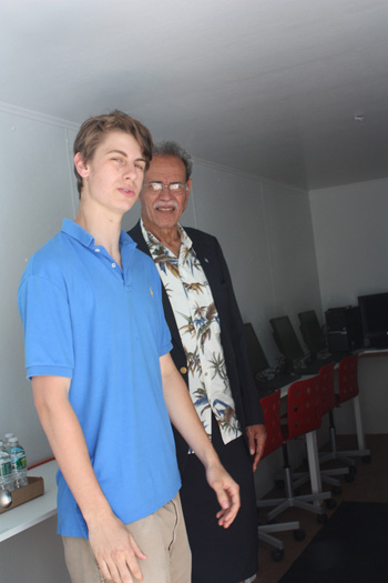 Ben McLaughlin with Ambassador Winston Thompson inside the solar-powered lab.