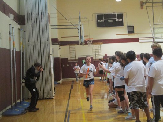 Students of Cara Nelson's seventh-grade class took part in a marathon relay on Friday to try and mimic as best they could what their teacher would be going through next month in the World Marathon Challenge.