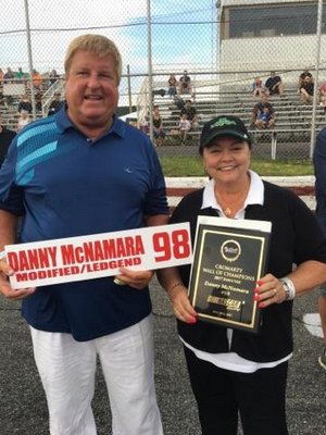 Danny McNamara with his wife, Denyse, who is holding his Wall of Champions plaque.