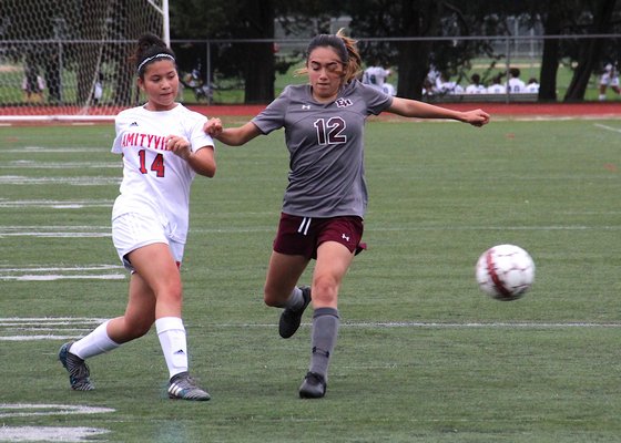 East Hampton sophomore Kayla Carpio tries to step in front of a pass. KYRIL BROMLEY