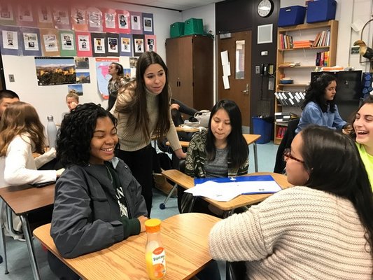 Paula González, pictured second from left, helps students in Sarah Trujillo Underhill's 11th grade class at Southampton High School. COURTESY MARY JANE GREENFIELD