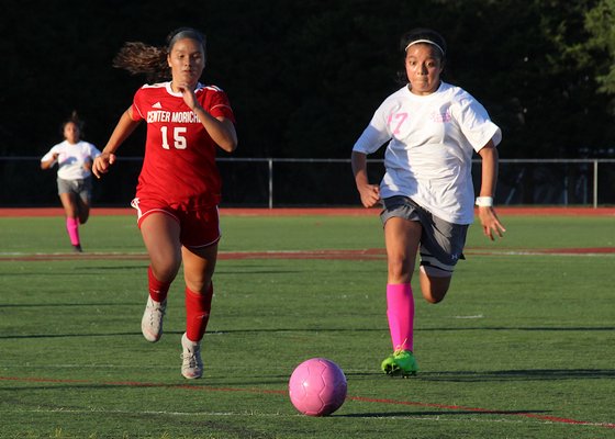 East Hampton junior Sofia Garcia and a Center Moriches player converge on the ball. KYRIL BROMLEY