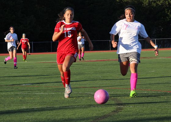 East Hampton junior Sofia Garcia and a Center Moriches player converge on the ball. KYRIL BROMLEY