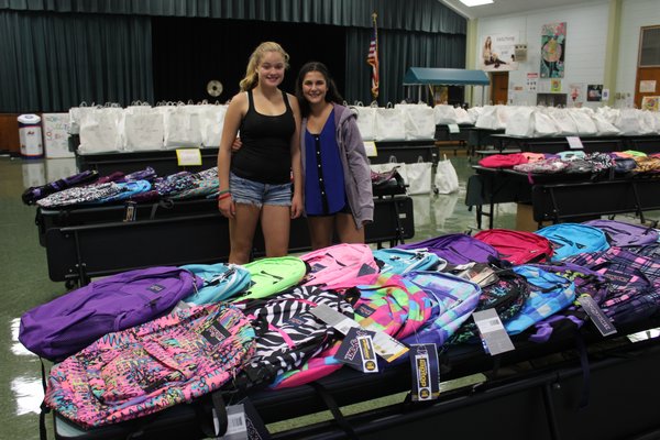 RaeAnn Spinner, left, 13, and Ariana DeMattei, who raised $10,000 to provide school supplies to children in need in the Westhampton community. BY CAROL MORAN
