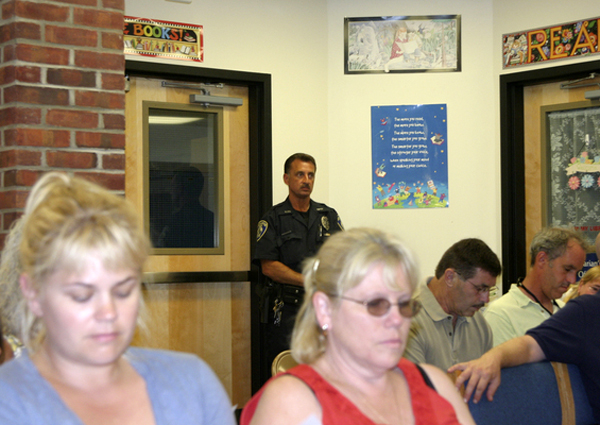 A Southampton Town Police officer was posted at the door to the meeting Monday.