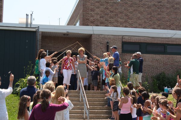 Westhampton Beach Elementary School students, faculty and parents wish kindergarten teacher Eloise Carter, secretary Nancy Cummings and third-grade teacher Debra Mazzio a warm goodbye on Friday, June 21. COURTESY MARIA CUNNEEN