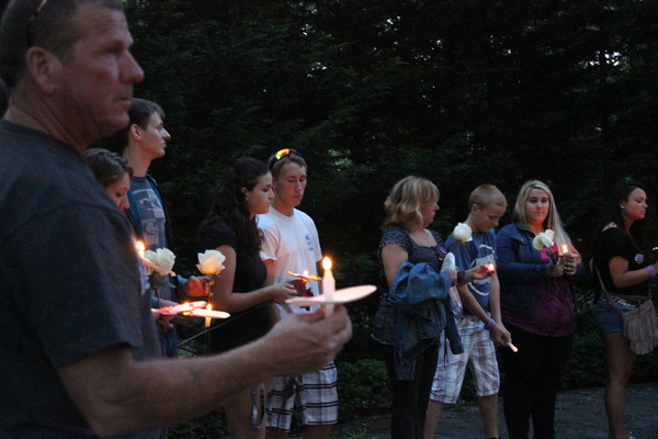 Friends of Cameron Nicholls, who was killed tragically in a car accident last year at 18, gathered in the East Quogue village green Tuesday night for a candlelight vigil. CAROL MORAN