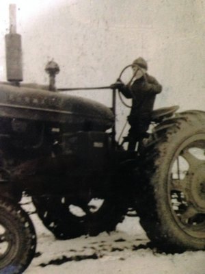 A young Cliff Foster on a tractor.