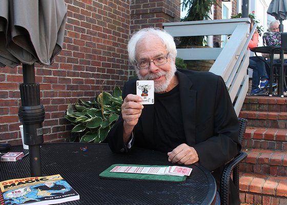 Allan Zola Kronzek, the author of "Grandpa Magic," performing card tricks and brain teasers at SagTown in Sag Harbor on Thursday, November 2.   KYRIL BROMLEY