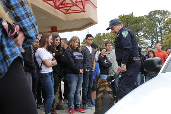 Riverhead Town Police Officer John Doscinski shows off his K-9 partner to Hampton Bays High School students during Friday's Career Day. KYLE CAMPBELL