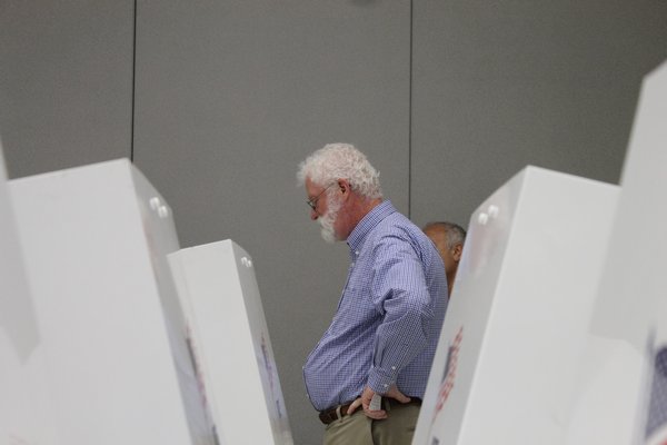 Westhampton Beach Board of Education member Jim Hulme waits for votes to be counted inside the Westhampton Beach High School polling area Tuesday night. KYLE CAMPBELL