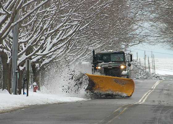 A plow in Amagansett on Friday morning. More snow is expected on Saturday.  KYRIL BROMLEY