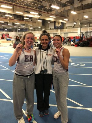 Mimi Fowkes, left, and JiJi Kramer, right, won the 1,500-meter race walk relay in a combined time of 16:40.26 at the Zeitler Relays. East Hampton girls track head coach Yani Cuesta is also pictured.