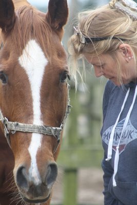 Diane Eissler with Sinatra during an exercise called "In the Present Moment" during an equine bereavement session at Spirit's Promise Equine Rescue in Riverhead last week. CAILIN RILEY