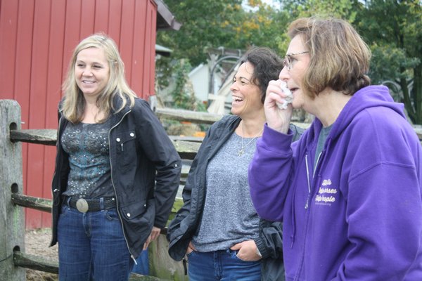 From left, Elizabeth McDowell, hospice social worker Angela Byrns, and Minna Waldeck share a lighthearted moment during last week's equine bereavement program. CAILIN RILEY