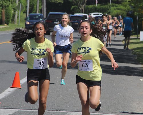 Nashaly Penafiel, left, and Daniela Chavez cross the finish line together. KYRIL BROMLEY